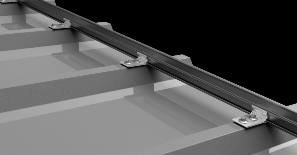 Silver metallic rail with small bolted brackets mounted on a segmented grey surface.